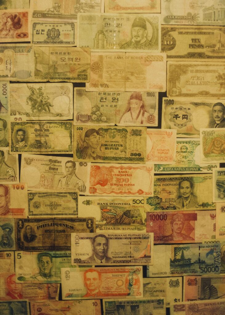 A collage of various international banknotes from different countries, featuring multiple colors, denominations, and portraits—perfect for travelers seeking practical travel information or planning a trip to Dive Spot Asia in Boljoon Cebu.